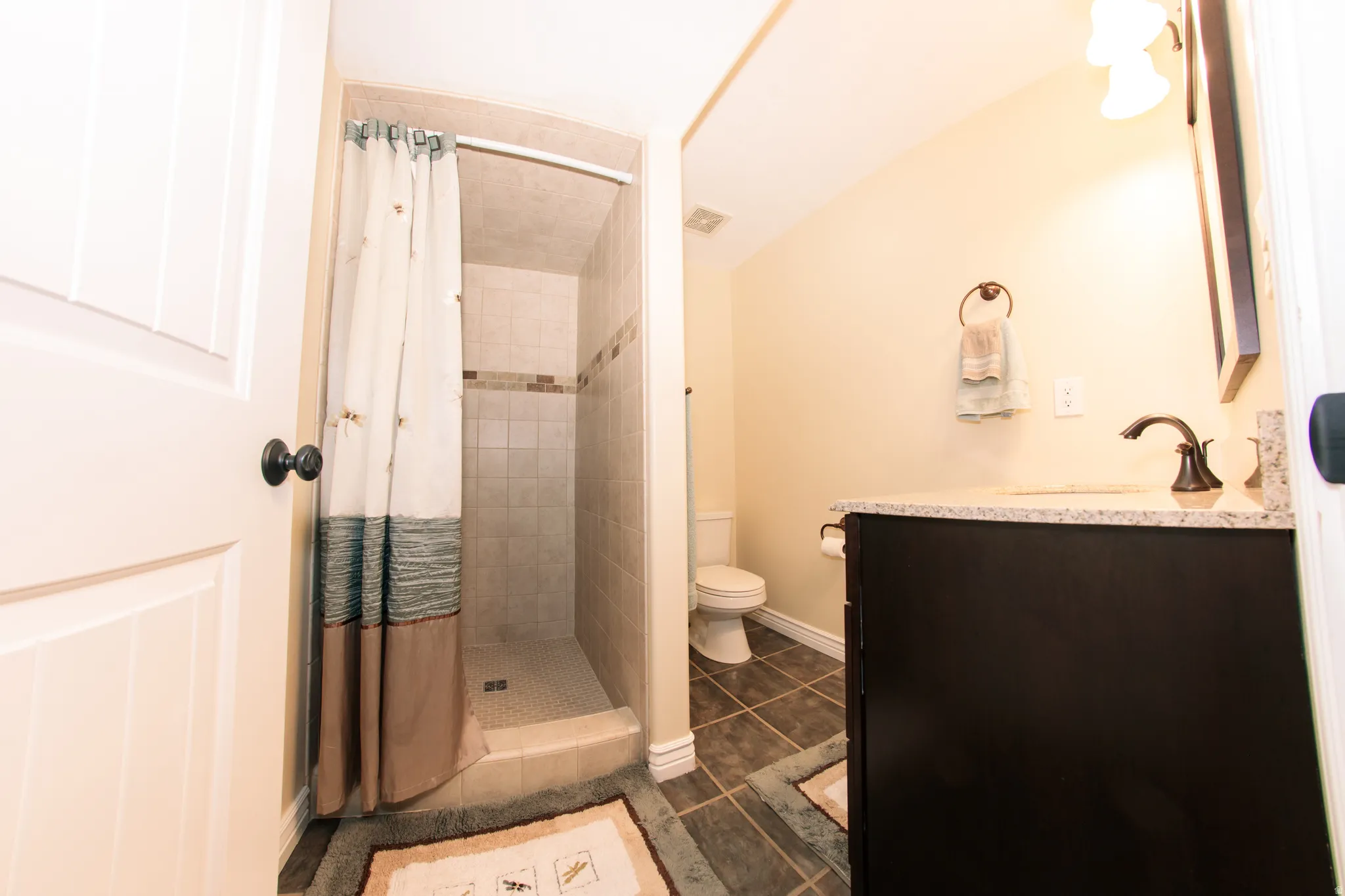 Walk-in shower with tiled surround and decorative accent band