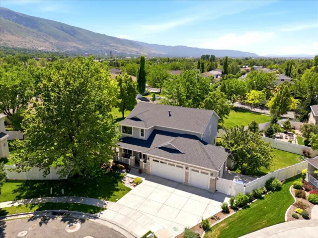 Two-story residence featuring a dark shingle roof and a light-colored exterior