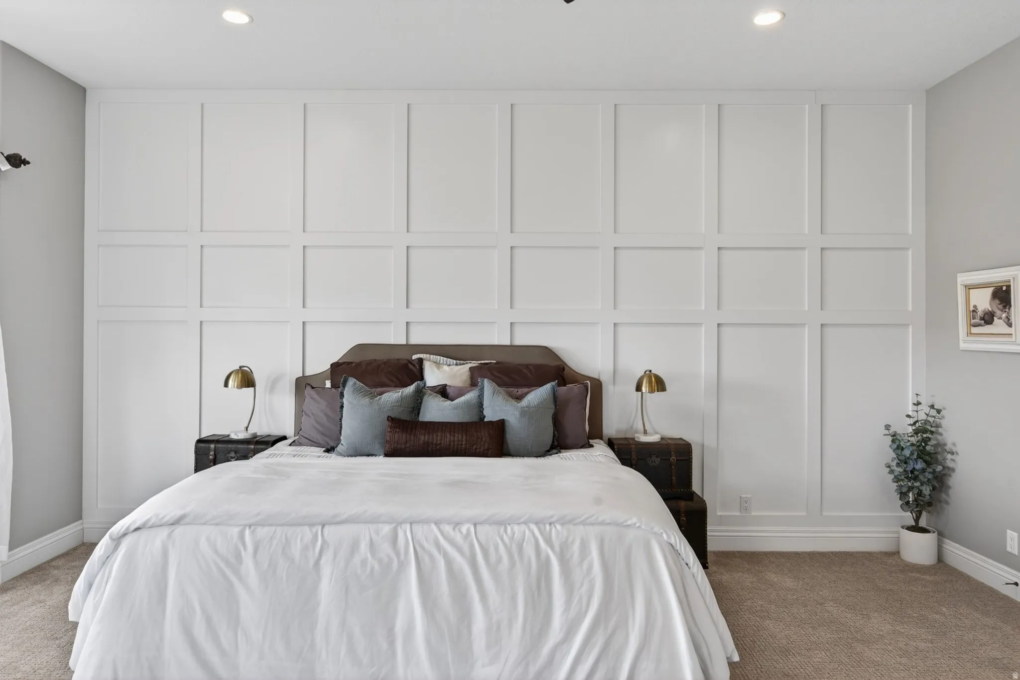 Accent wall featuring wainscoting and crown molding
