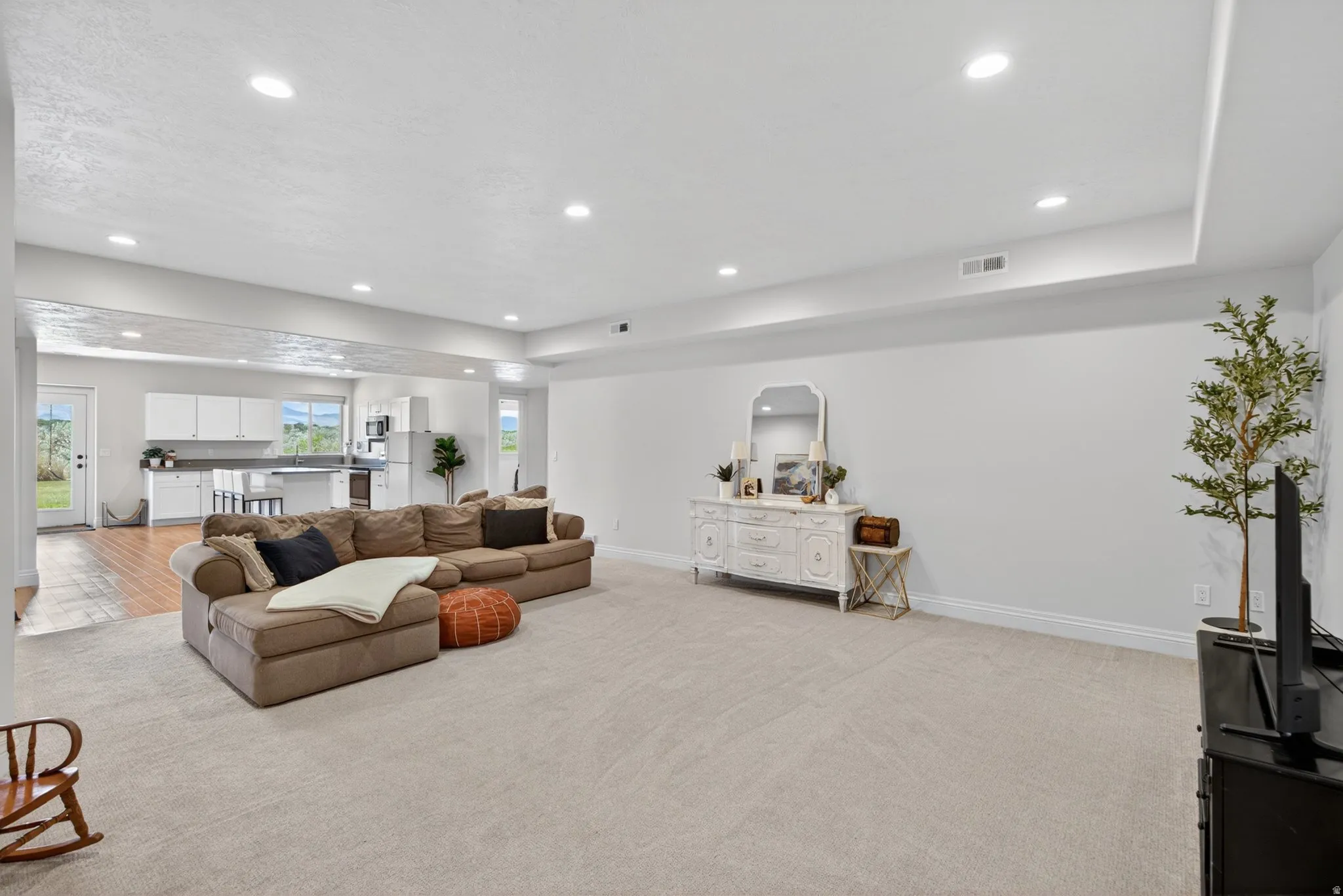 Open-concept living area with recessed lighting.