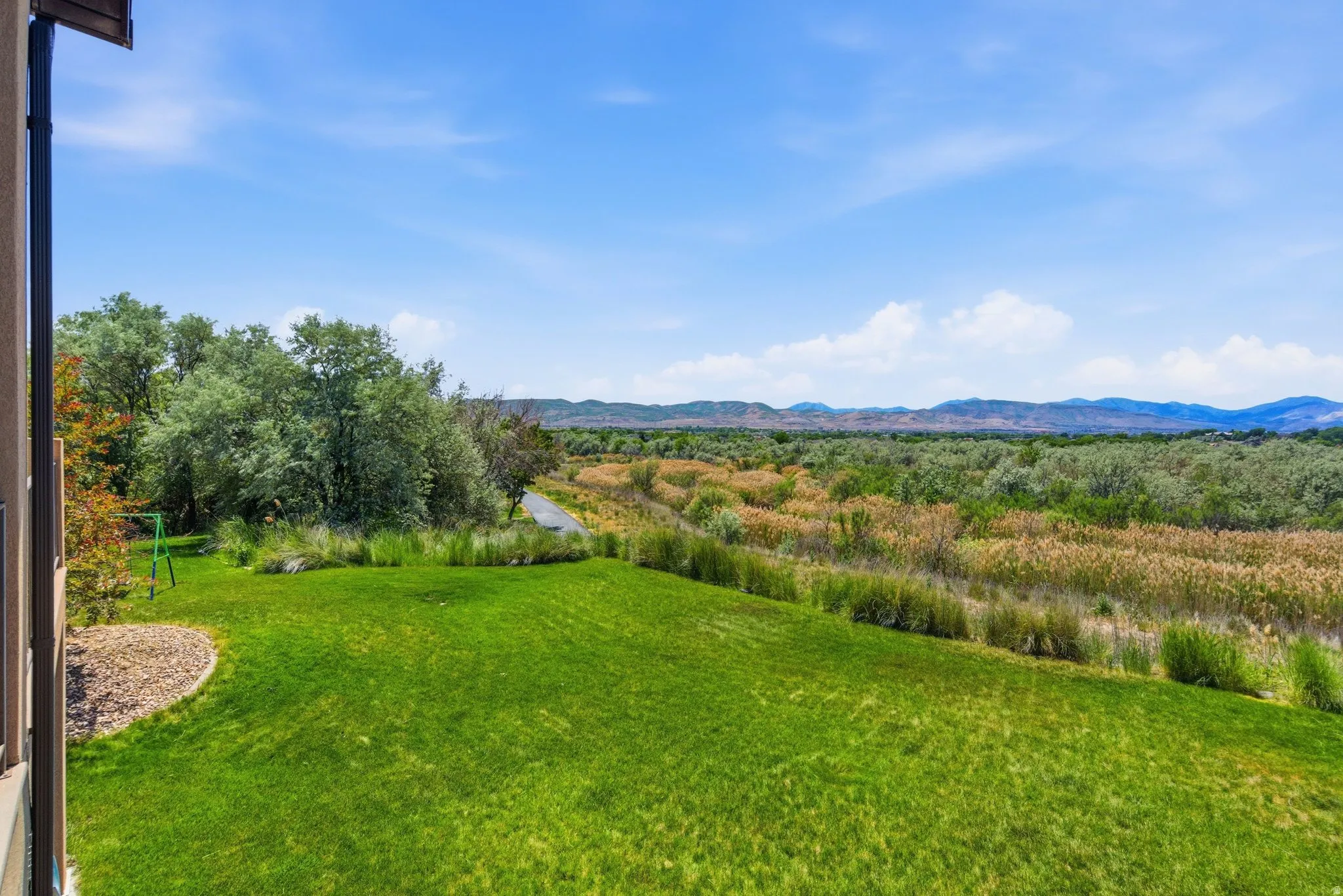 Expansive green lawn with mountain backdrop