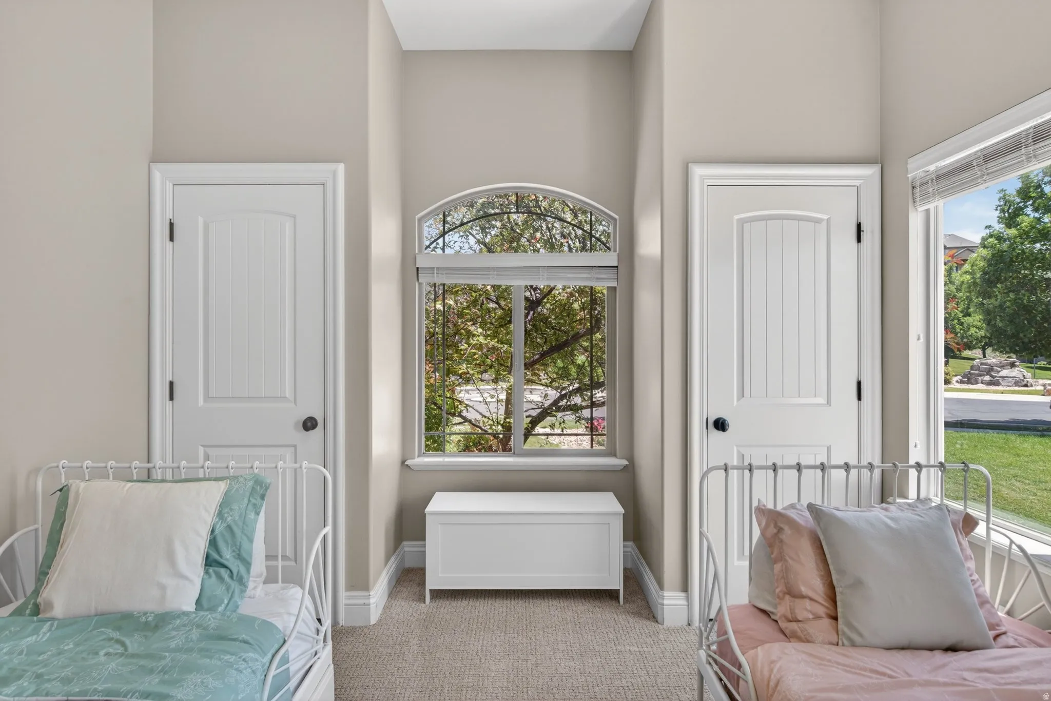 Room featuring neutral-toned walls, plush carpeting, and white trim