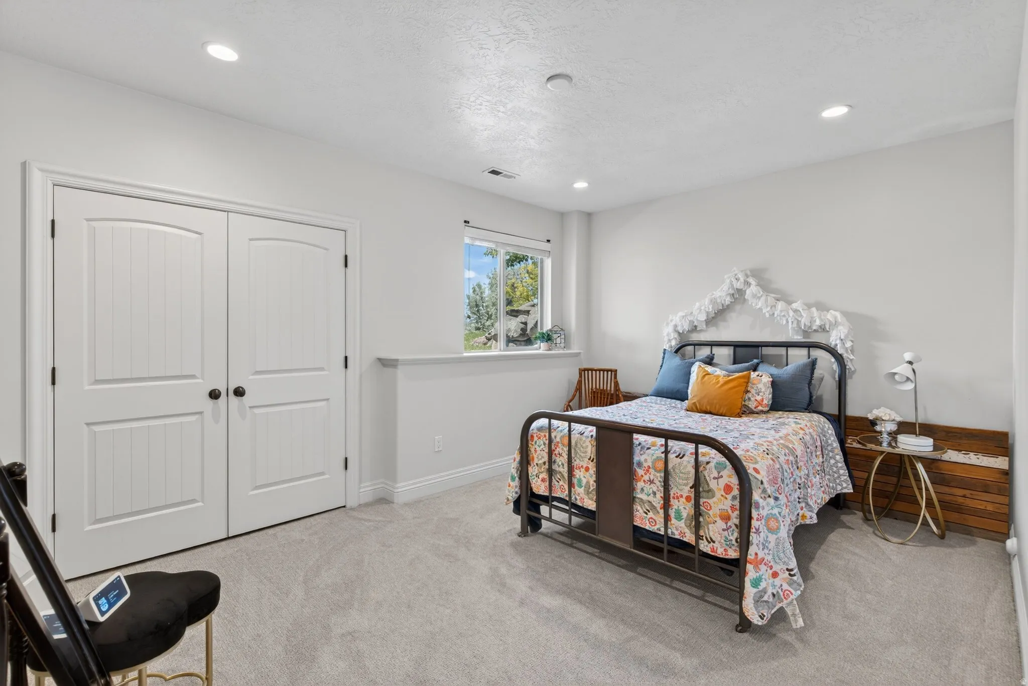Bright room with recessed lighting and light gray carpet