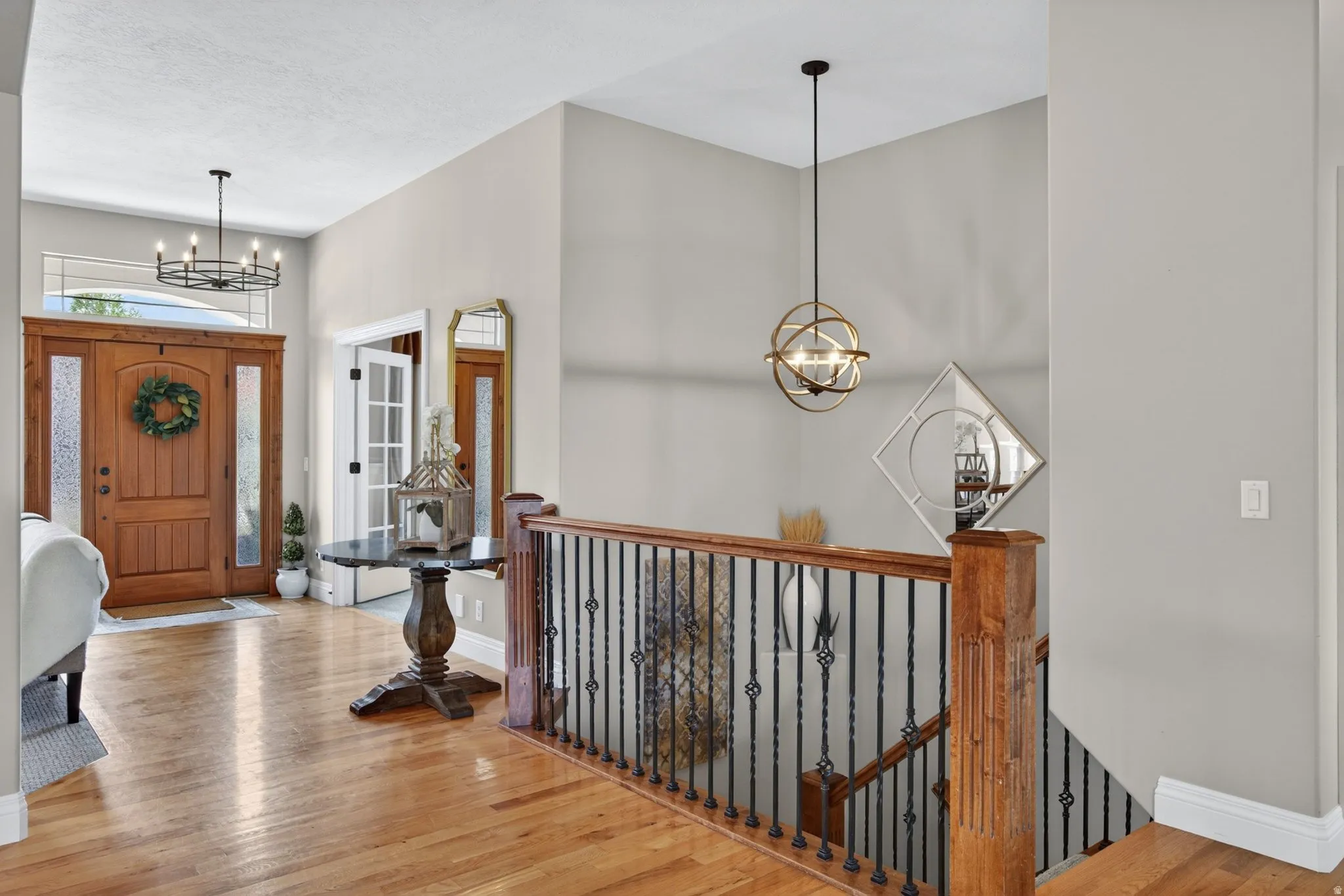 Hardwood flooring throughout the entry and upper landing