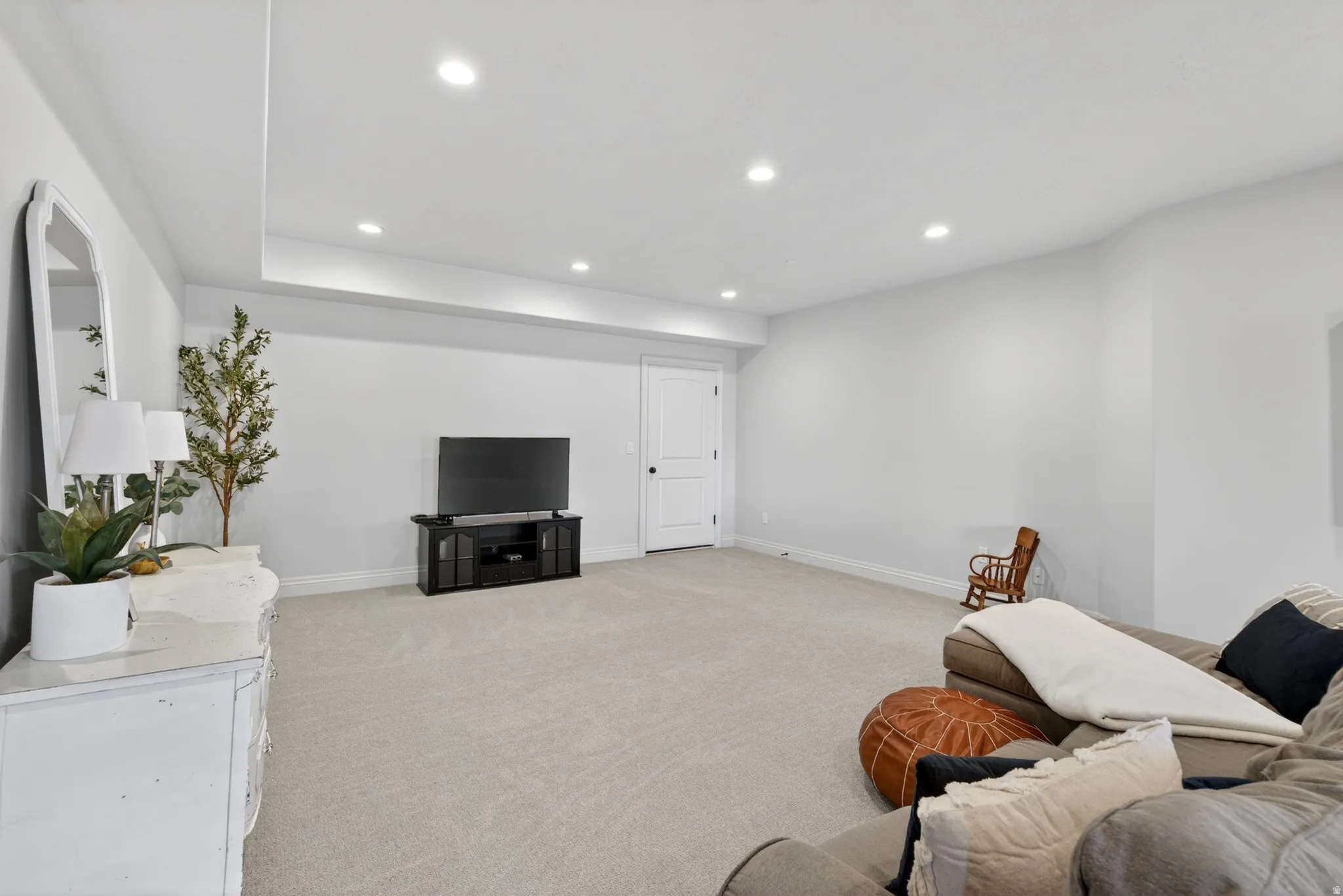 Spacious room featuring light-colored carpeting and recessed lighting