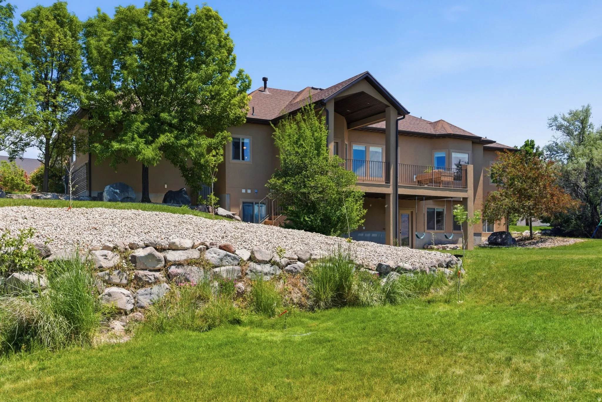 Terraced landscaping with a rock retaining wall and gravel accents