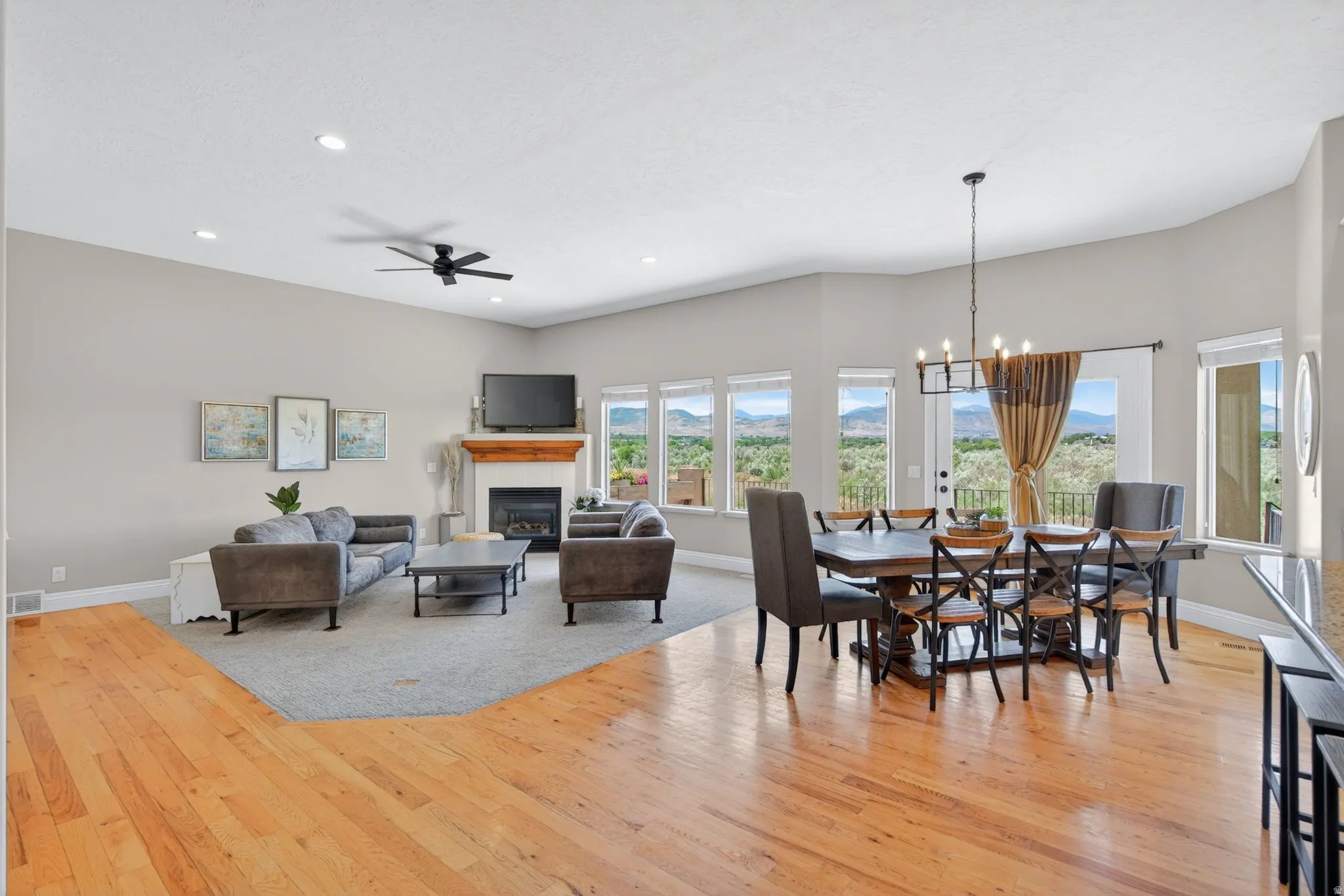 Open-concept living area with 10 foot ceilings and recessed lighting