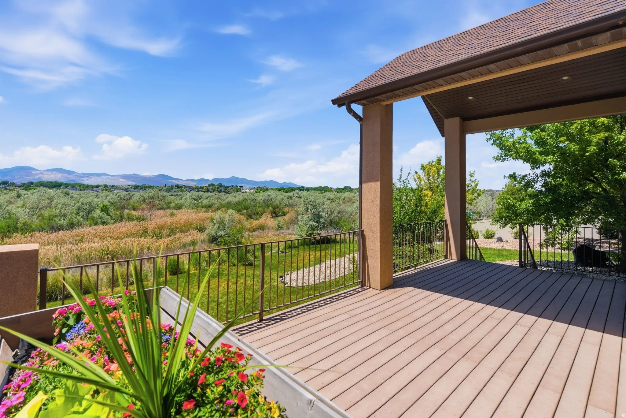 Expansive covered outdoor deck featuring composite decking, a sturdy railing, and ample space for outdoor enjoyment