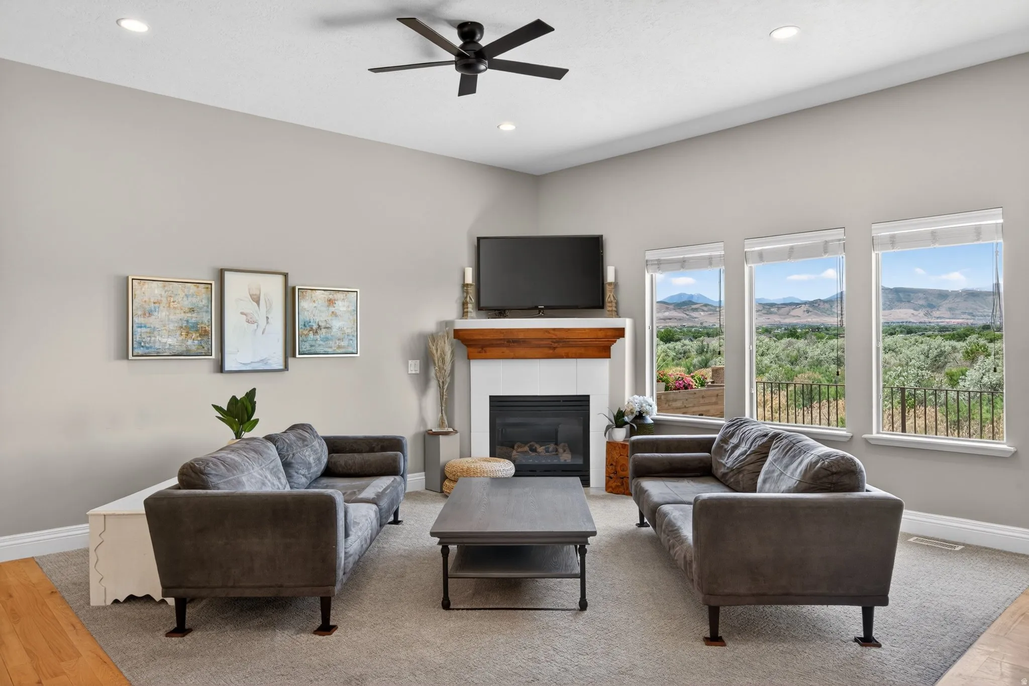 Living area featuring 10 foot ceilings, recessed lighting, and a ceiling fan
