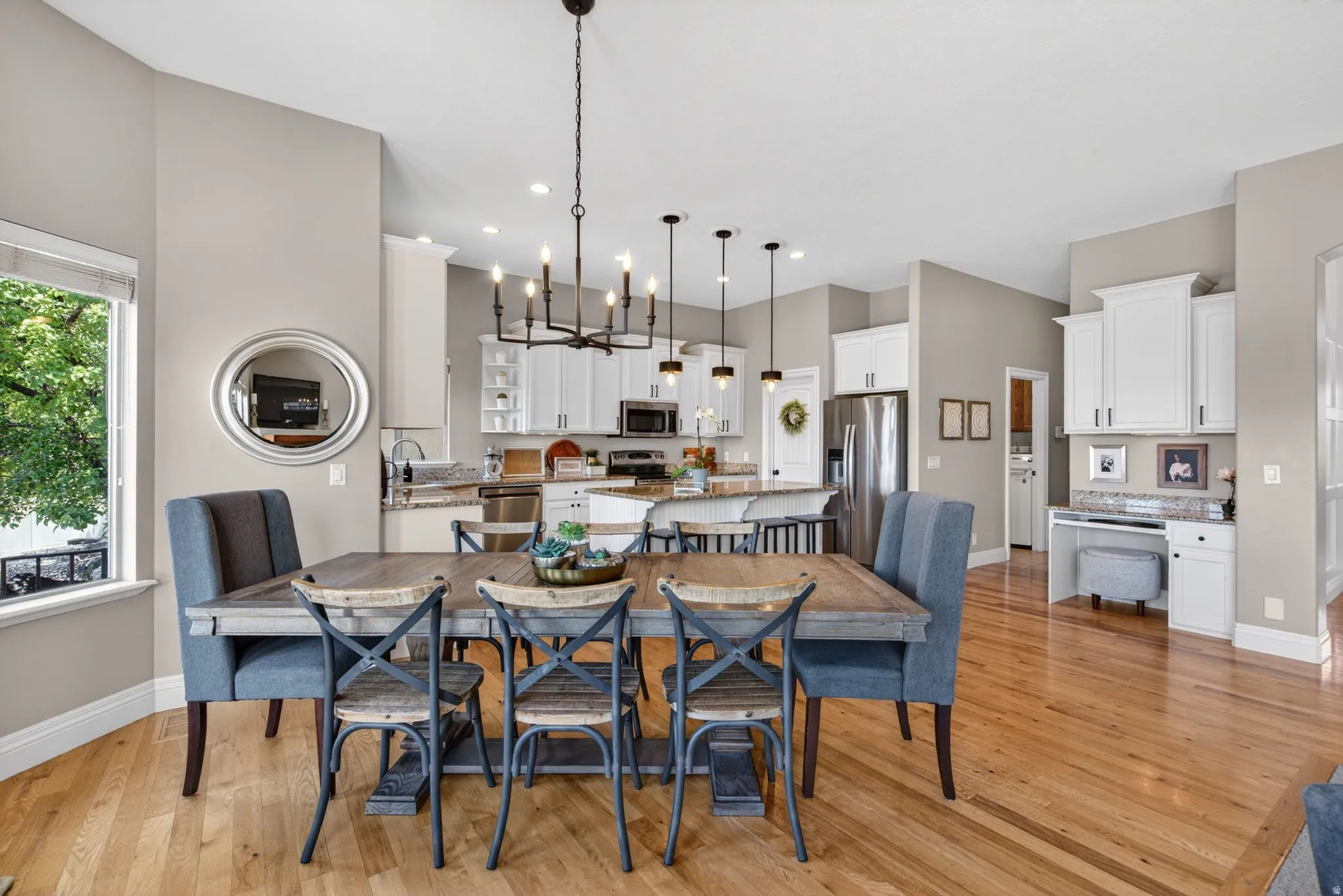 Open-concept dining and kitchen area featuring wood-finish flooring.