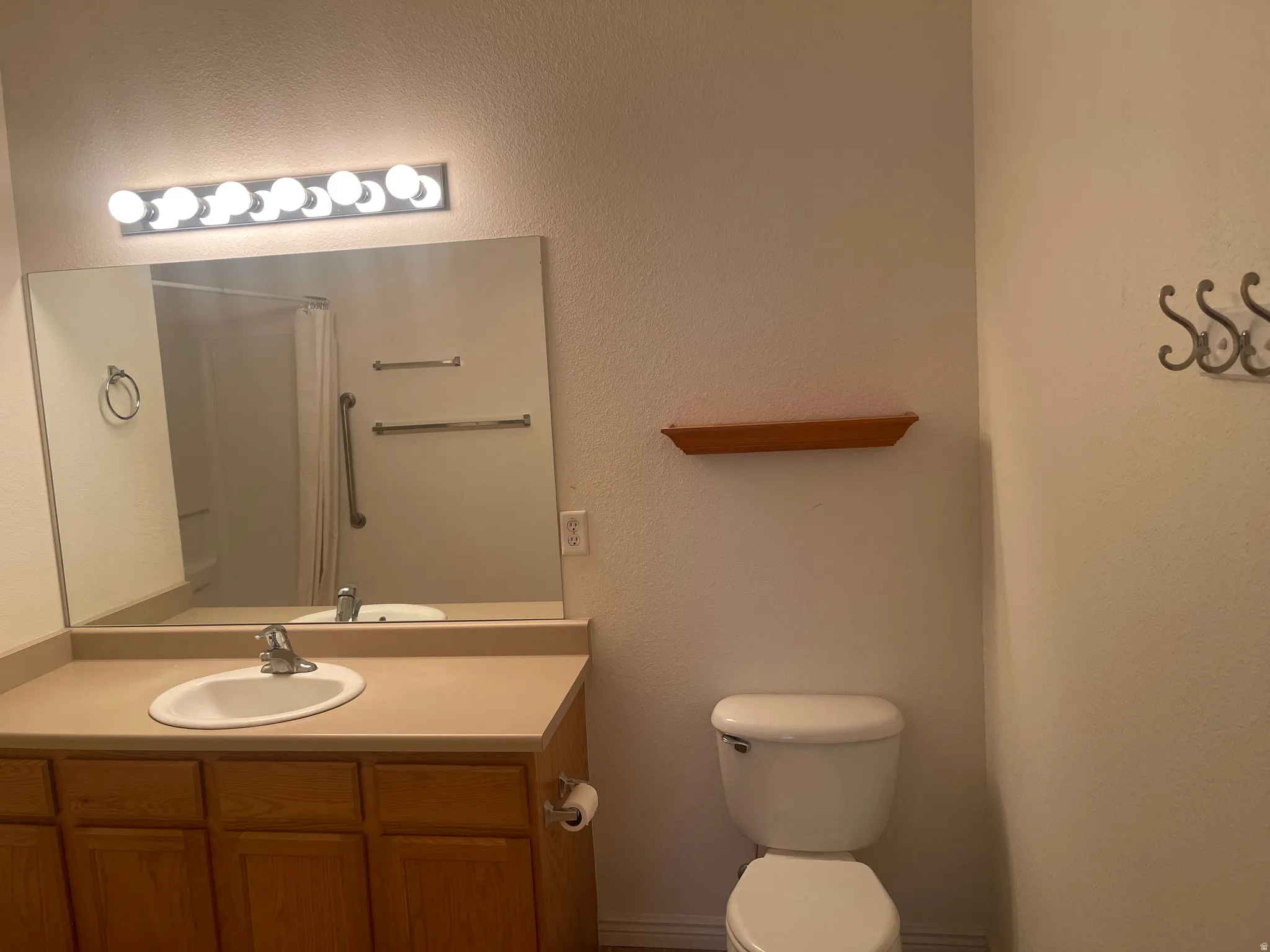 Bathroom vanity with an integrated sink and wood-finish cabinetry