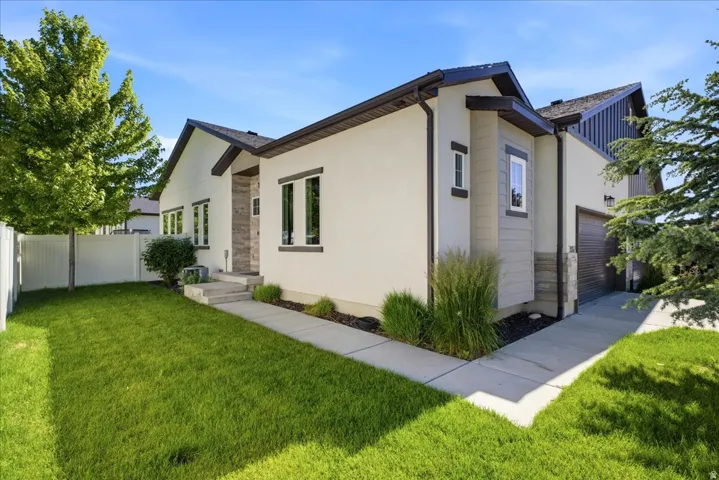 Contemporary exterior featuring light-toned stucco and dark trim accents