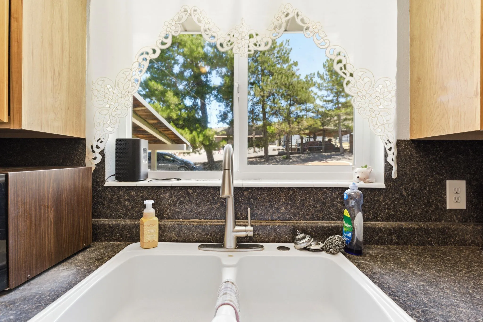 Kitchen sink with a dual basin, a high-arc faucet, and granite-look countertops