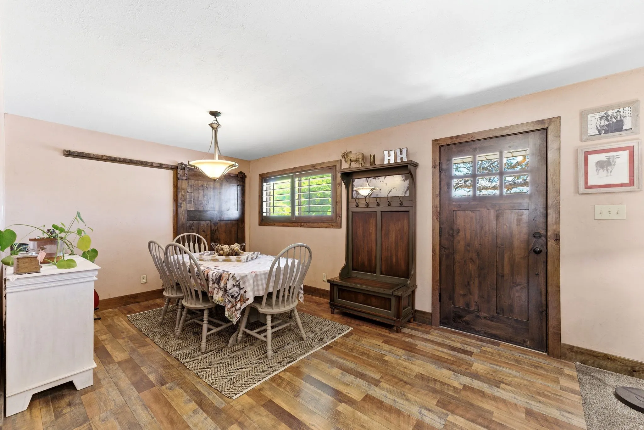 Dining area featuring wood-finish flooring and a ceiling-mounted light fixture