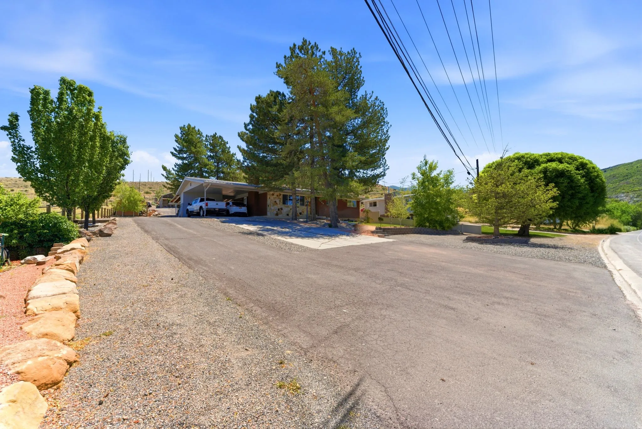 Spacious paved driveway with an additional gravel parking area, providing ample off-street parking