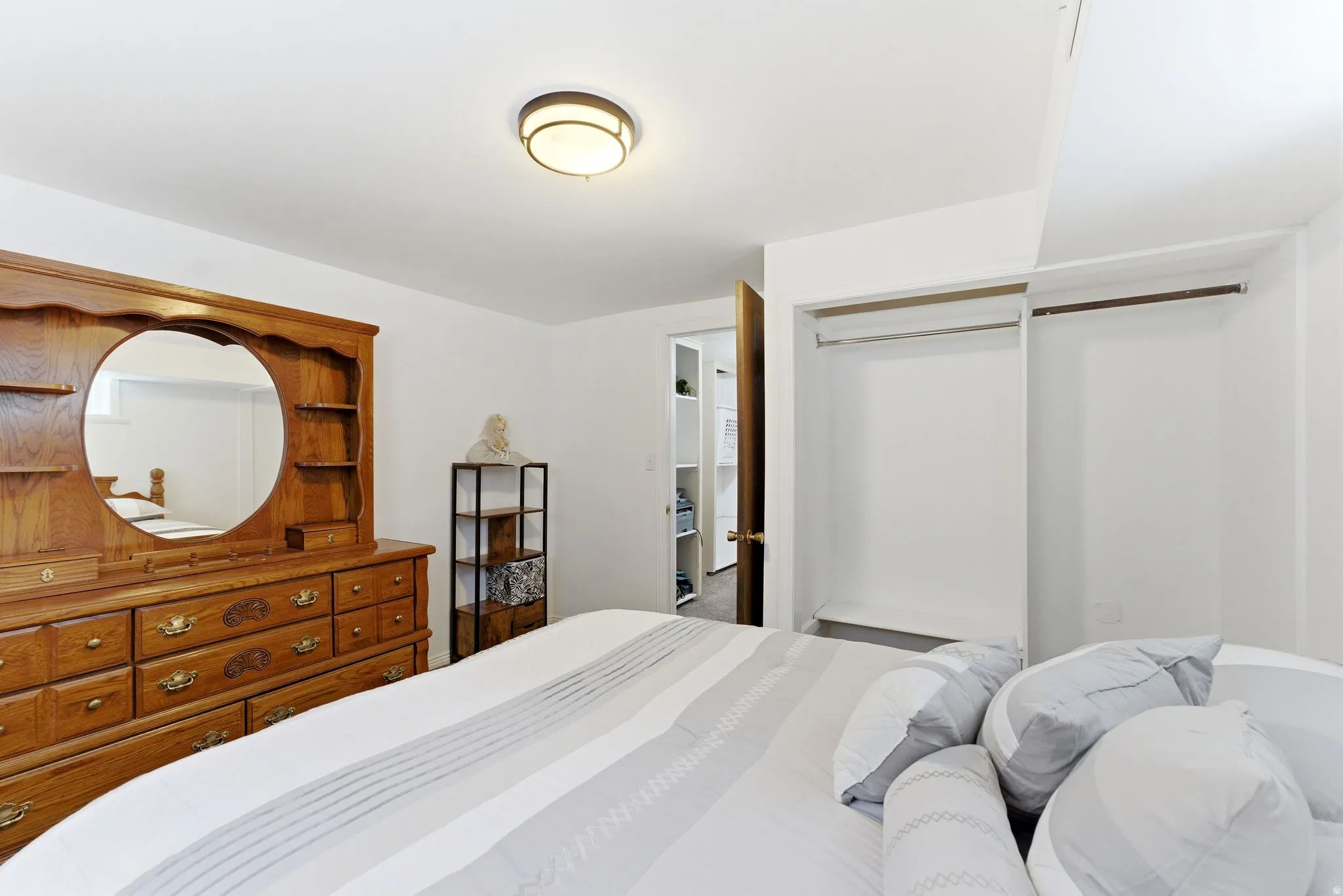 White walls complement the light-colored ceiling with a flush-mount light fixture