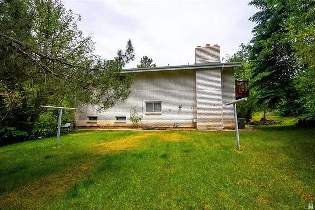 Expansive grassy yard with mature trees