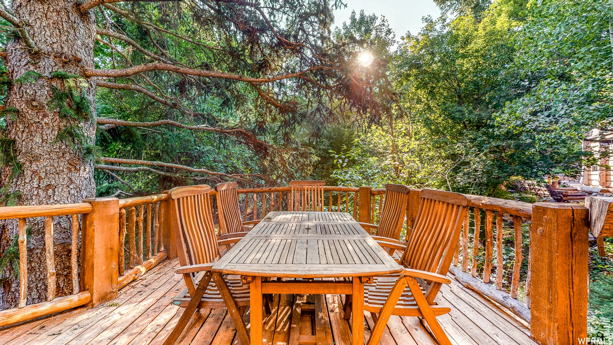 Expansive wood-finish deck with a natural wood railing