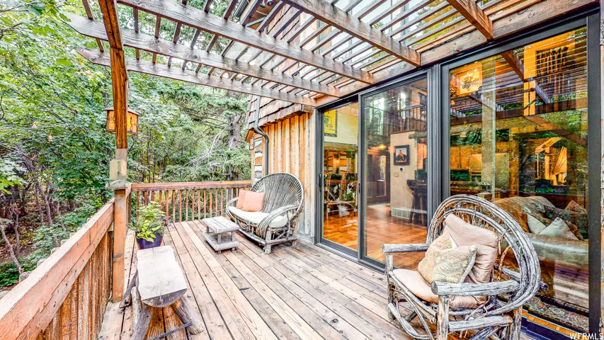 Expansive wood deck with a slatted pergola overhead