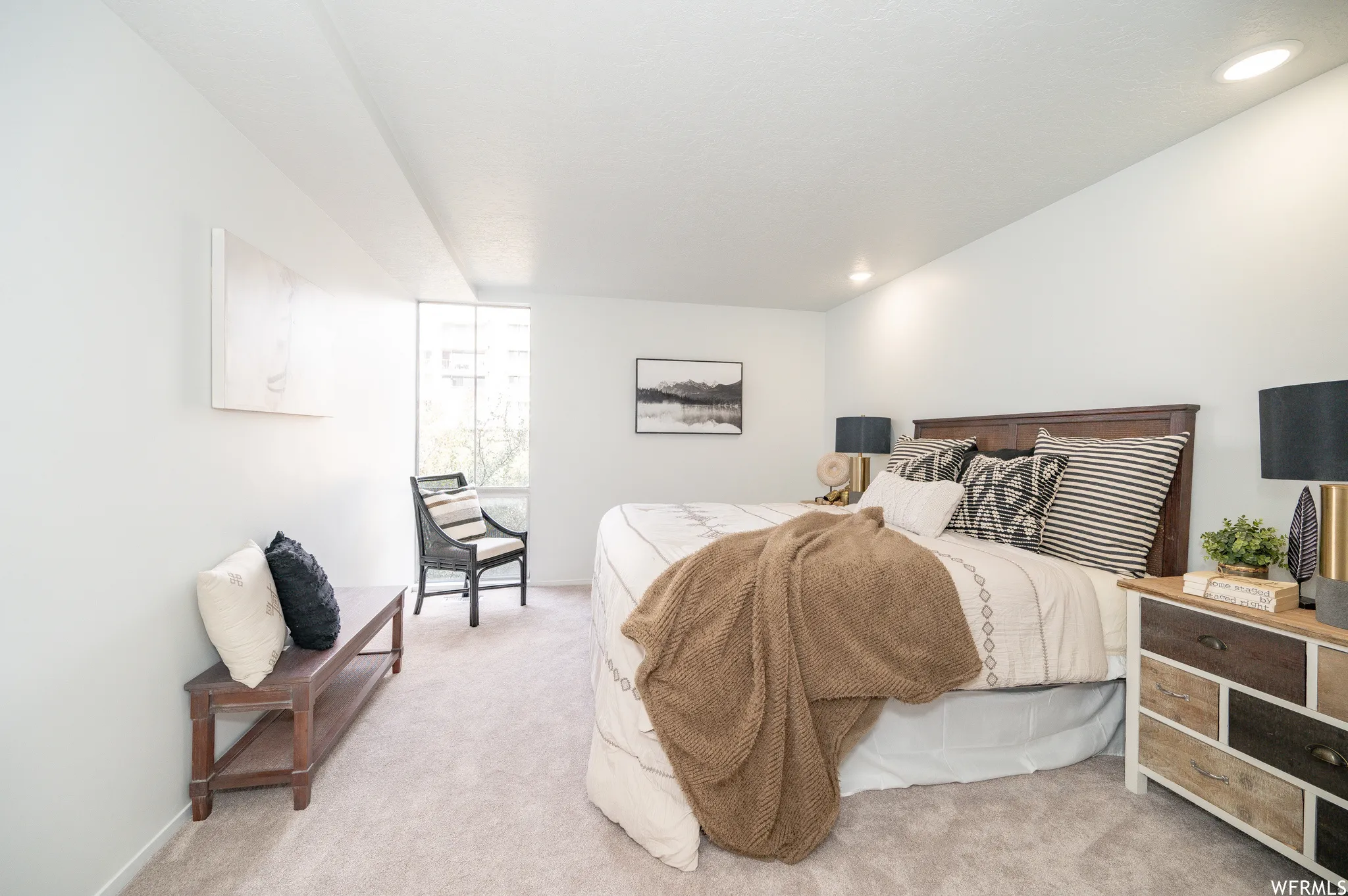 Spacious room featuring light-colored carpet flooring and recessed ceiling lighting