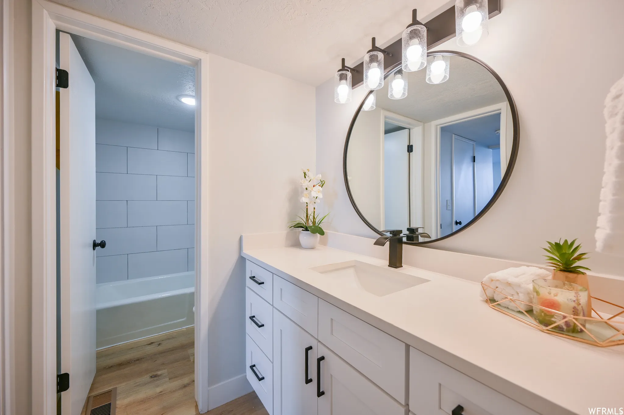 Modern bathroom vanity with a white countertop and integrated sink