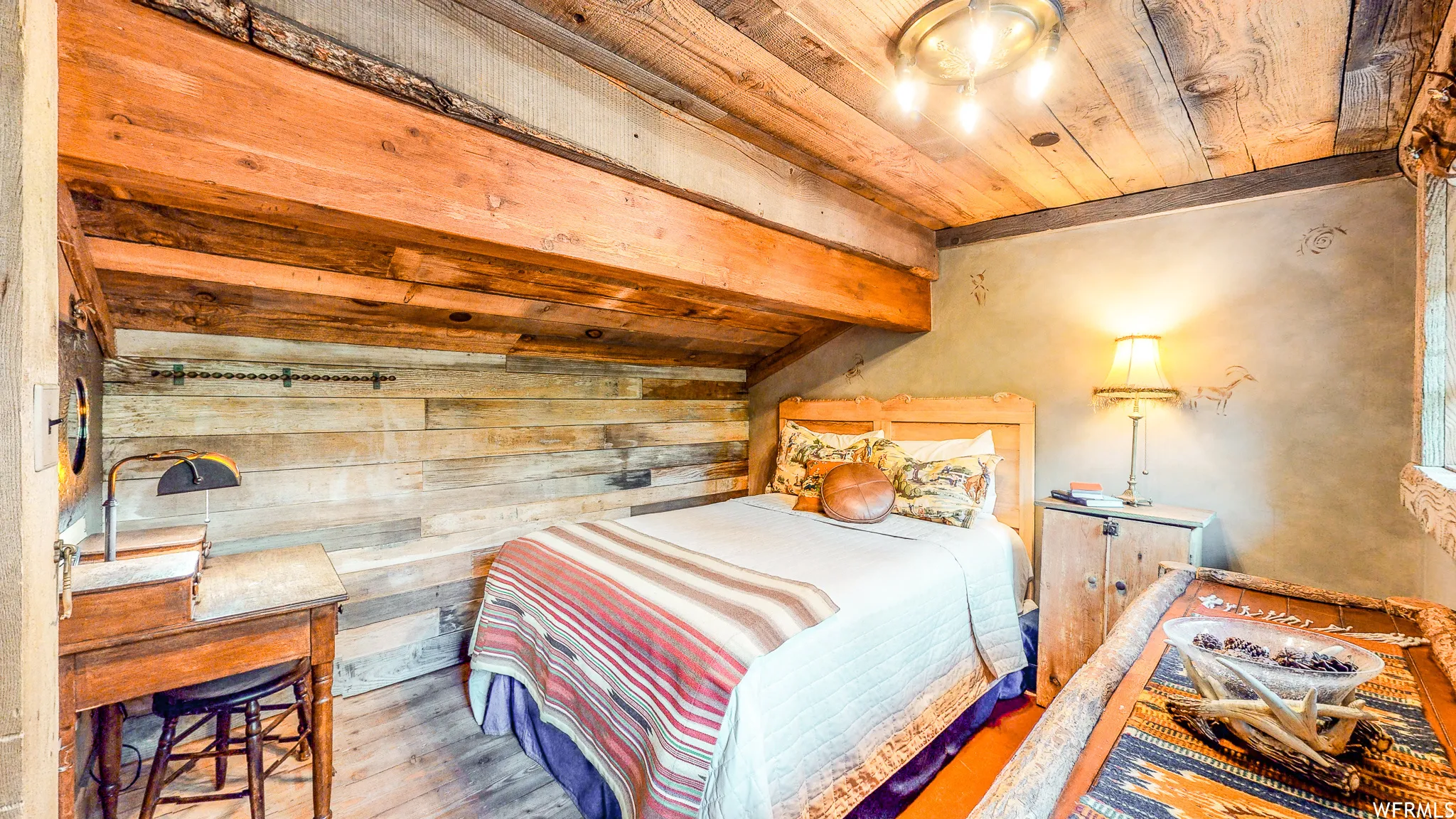 Wood-finish flooring with a wood plank ceiling and exposed beams