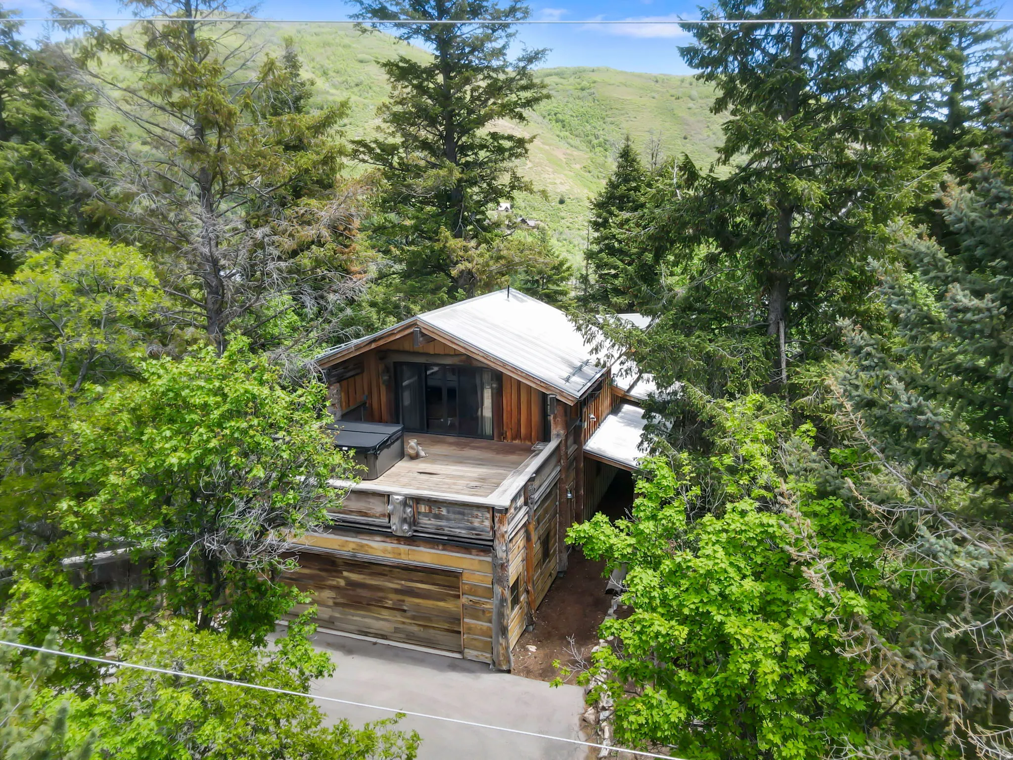 Rustic-style residence featuring natural wood siding and a metal roof