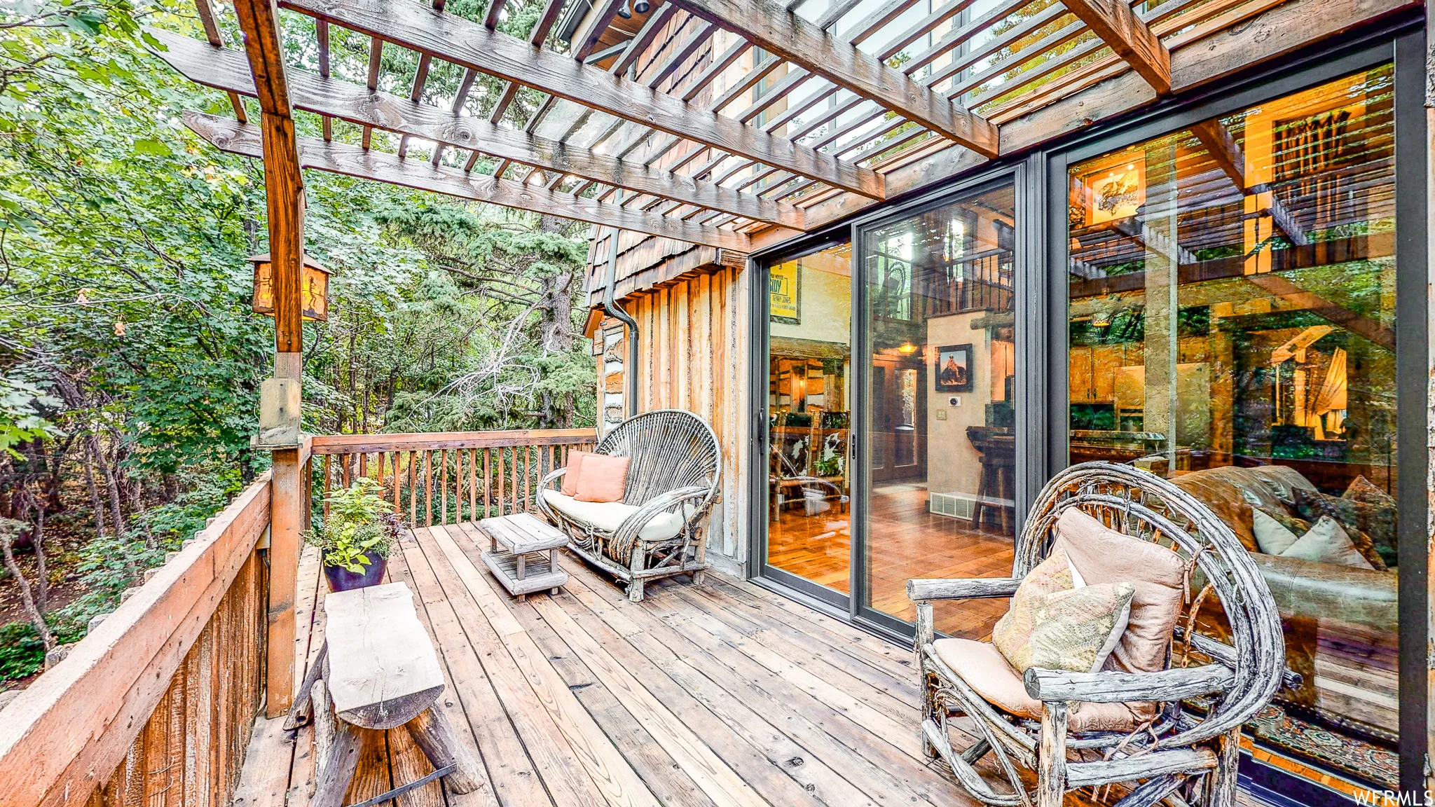 Expansive wood deck with a slatted pergola overhead