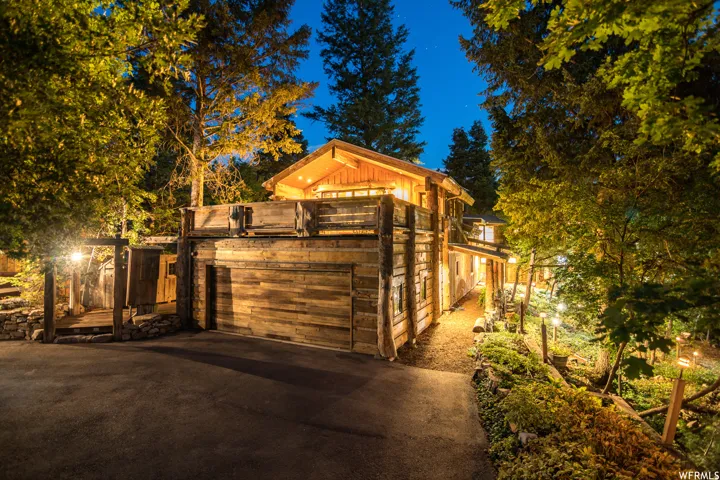 Rustic exterior featuring natural wood siding and a coordinating garage door