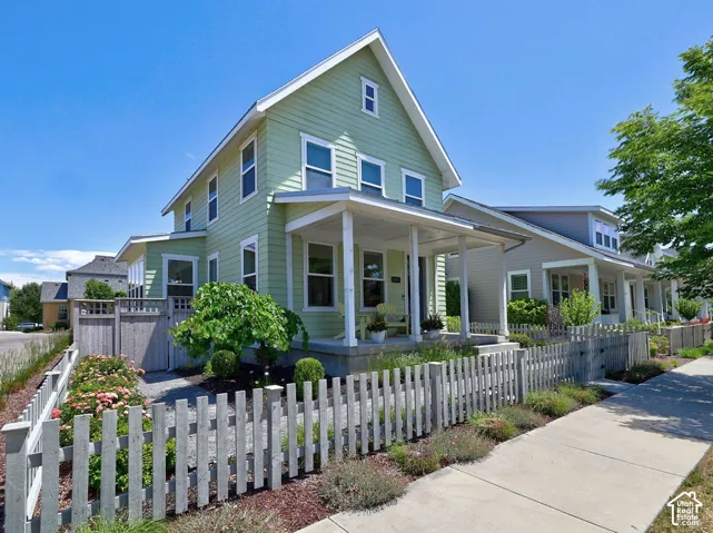 Two-story residence featuring light green siding and white trim