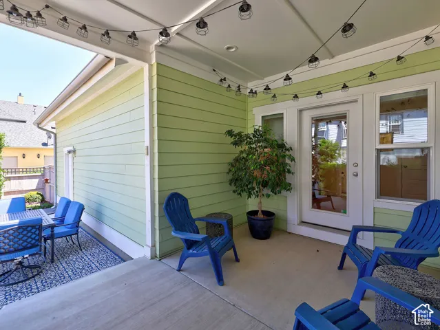 Covered patio featuring concrete flooring and a string of overhead lighting