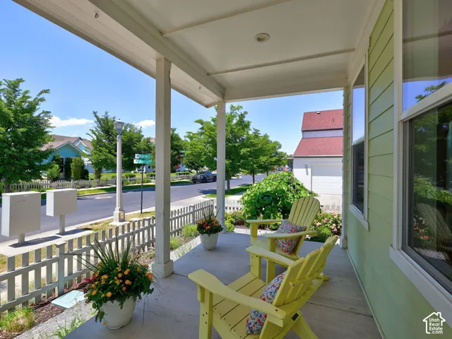 Covered porch with light green siding and white trim