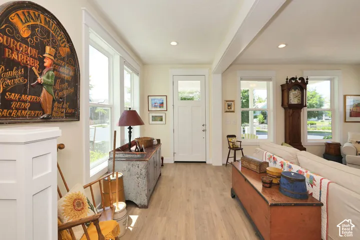 Light wood-finish flooring extending from the entryway into the living area