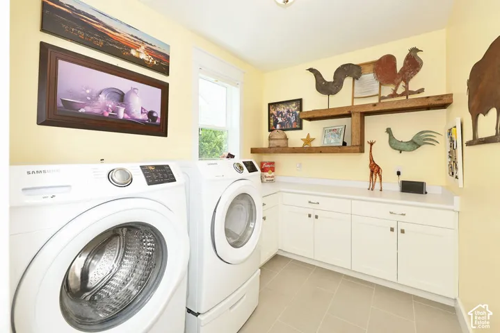 White cabinetry with brushed nickel hardware, light-toned countertop, and light-colored tile flooring