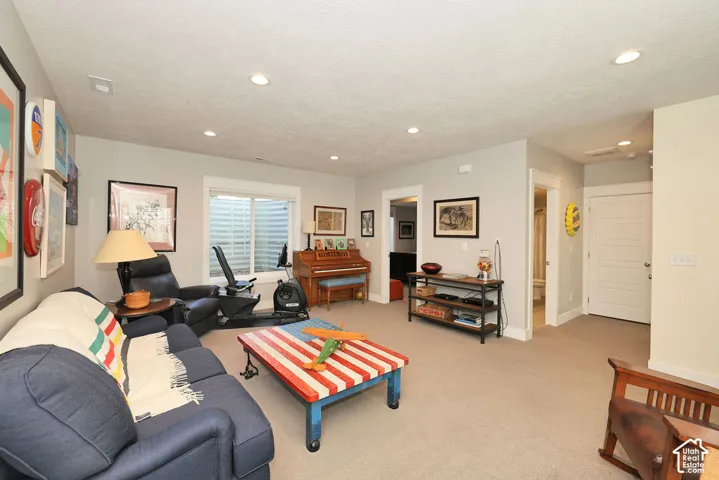 Spacious interior featuring neutral carpeting, recessed lighting, a white trim window, and light-toned walls