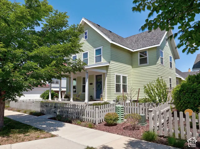 Light green exterior with white trim and a covered front porch