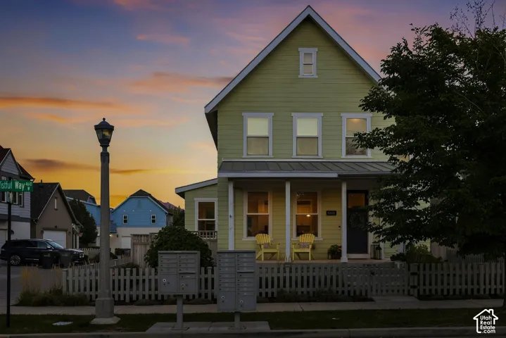Two-story exterior with siding, covered front porch, and pitched roof