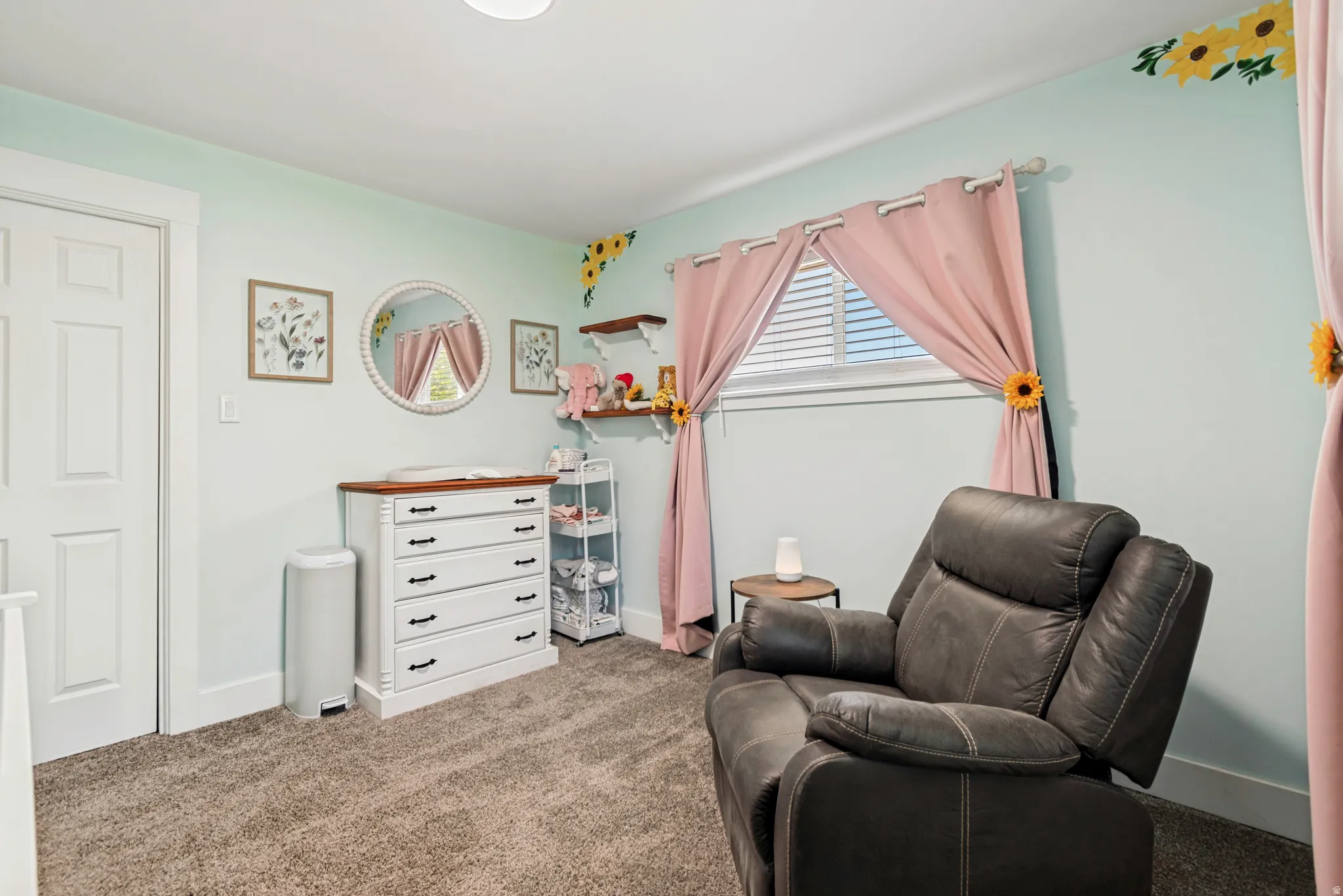 Carpeted room featuring a white paneled door, a window with horizontal blinds, and light-colored walls
