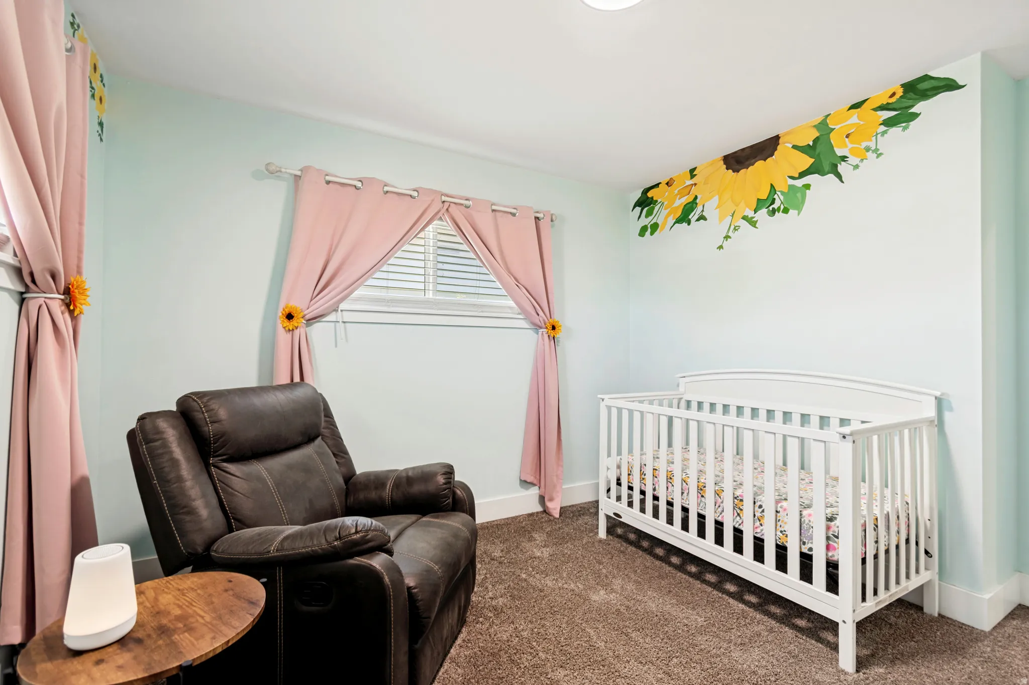 Room featuring soft blue walls, textured carpeting, and a built-in window with horizontal blinds