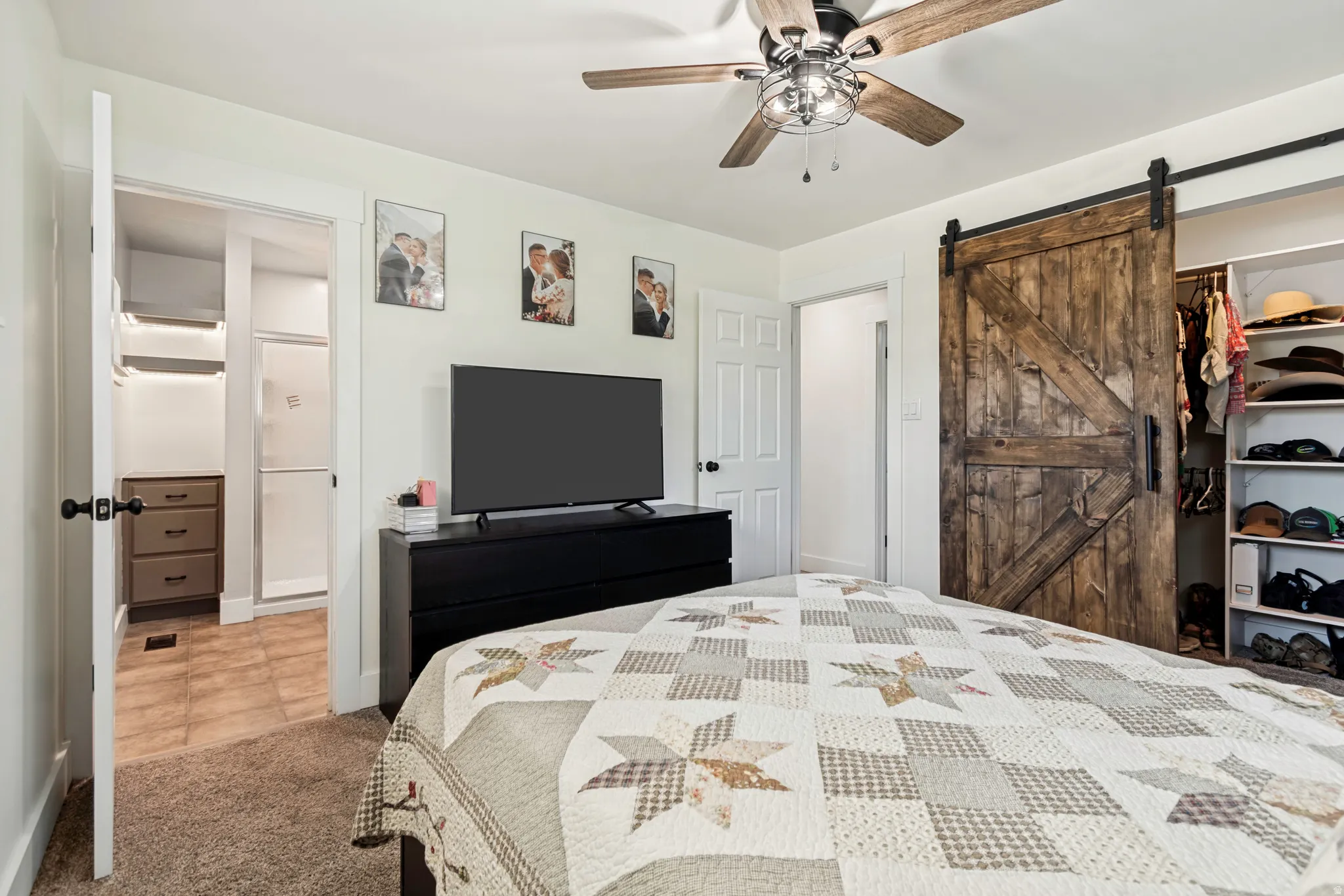 Bedroom featuring plush carpeting and a ceiling fan with integrated lighting