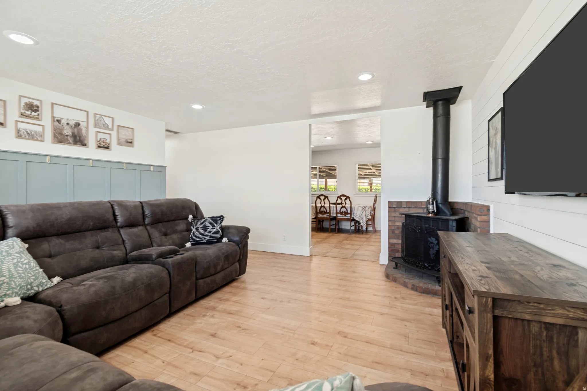 Living area featuring wood-finish flooring and recessed lighting