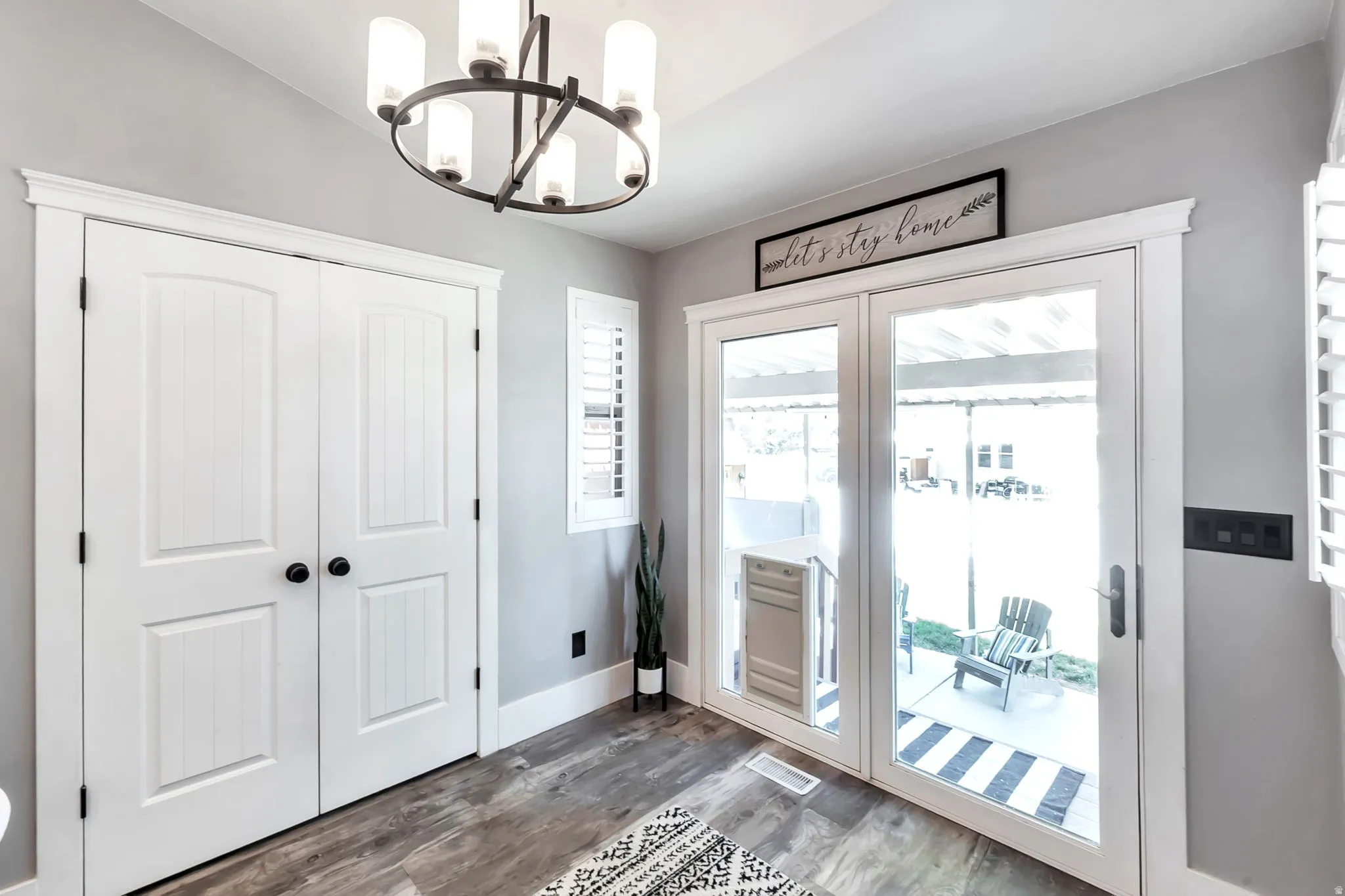 Floor-to-ceiling French doors provide abundant natural light and exterior access