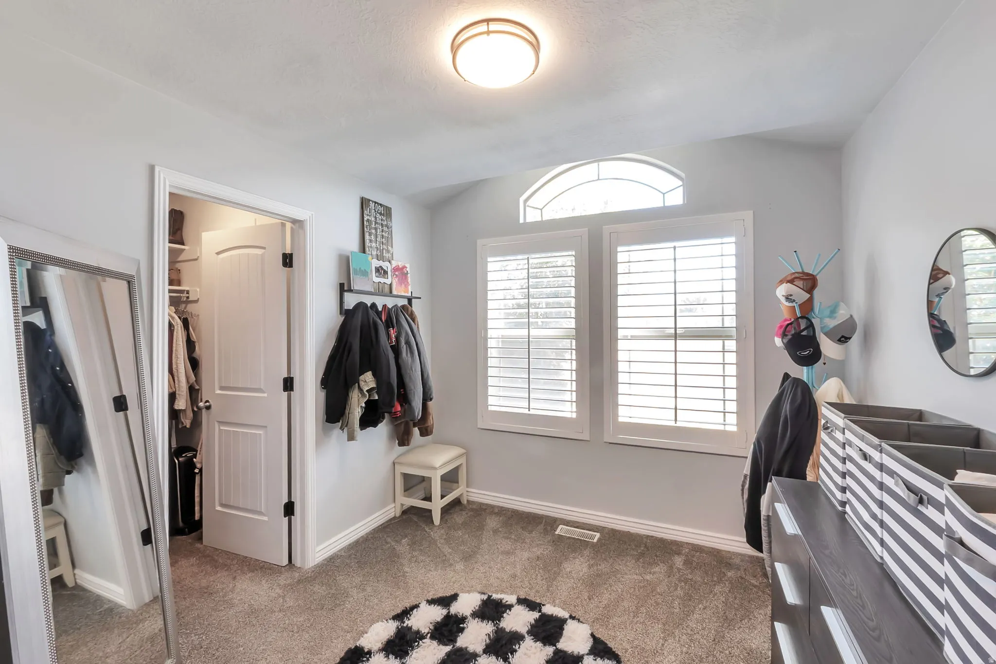 Room featuring light gray walls, gray carpet, and a flush mount ceiling light fixture