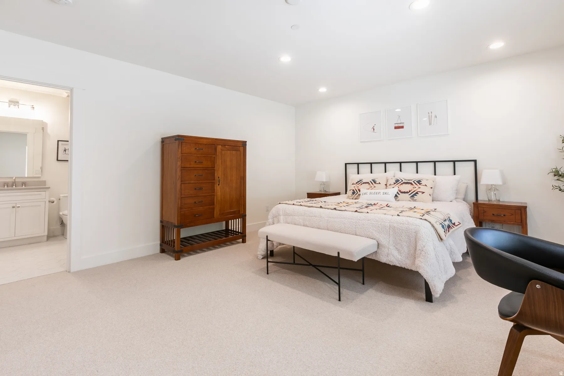 Expansive bedroom featuring recessed lighting, plush carpet flooring, and a wide entryway to a full bathroom