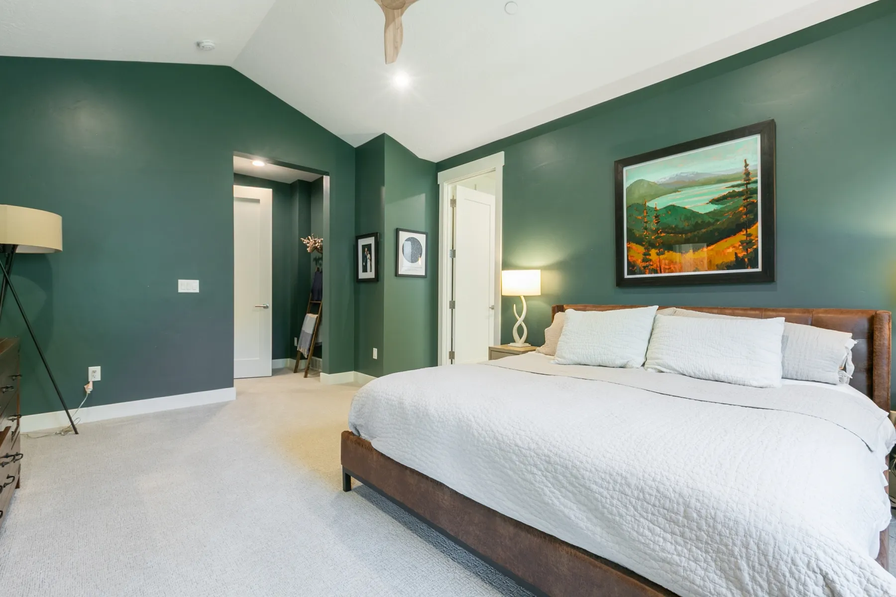 Bedroom featuring vaulted ceilings, plush carpet flooring, a ceiling fan, and accent lighting