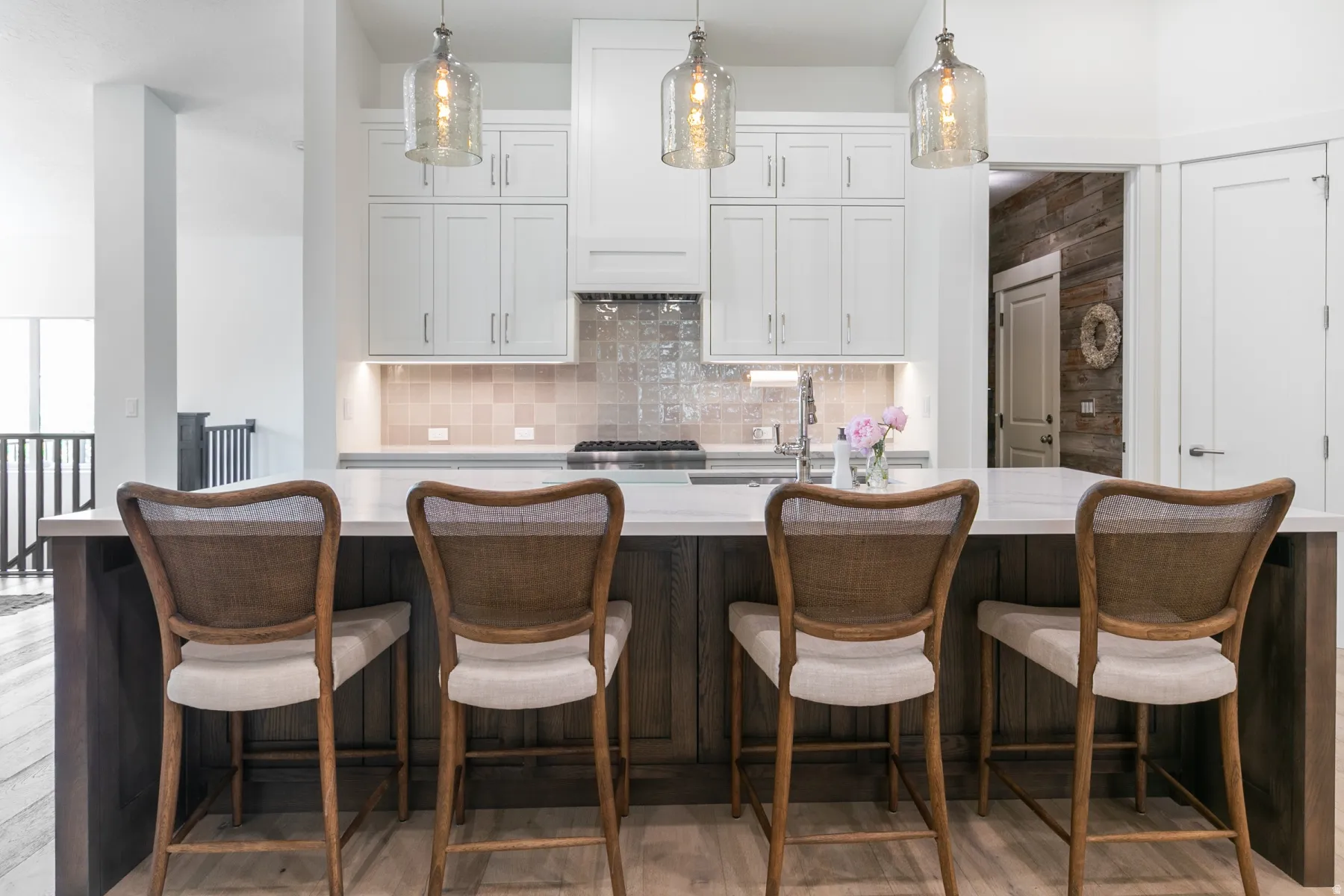 Kitchen island with white quartz countertop and wood-finish base