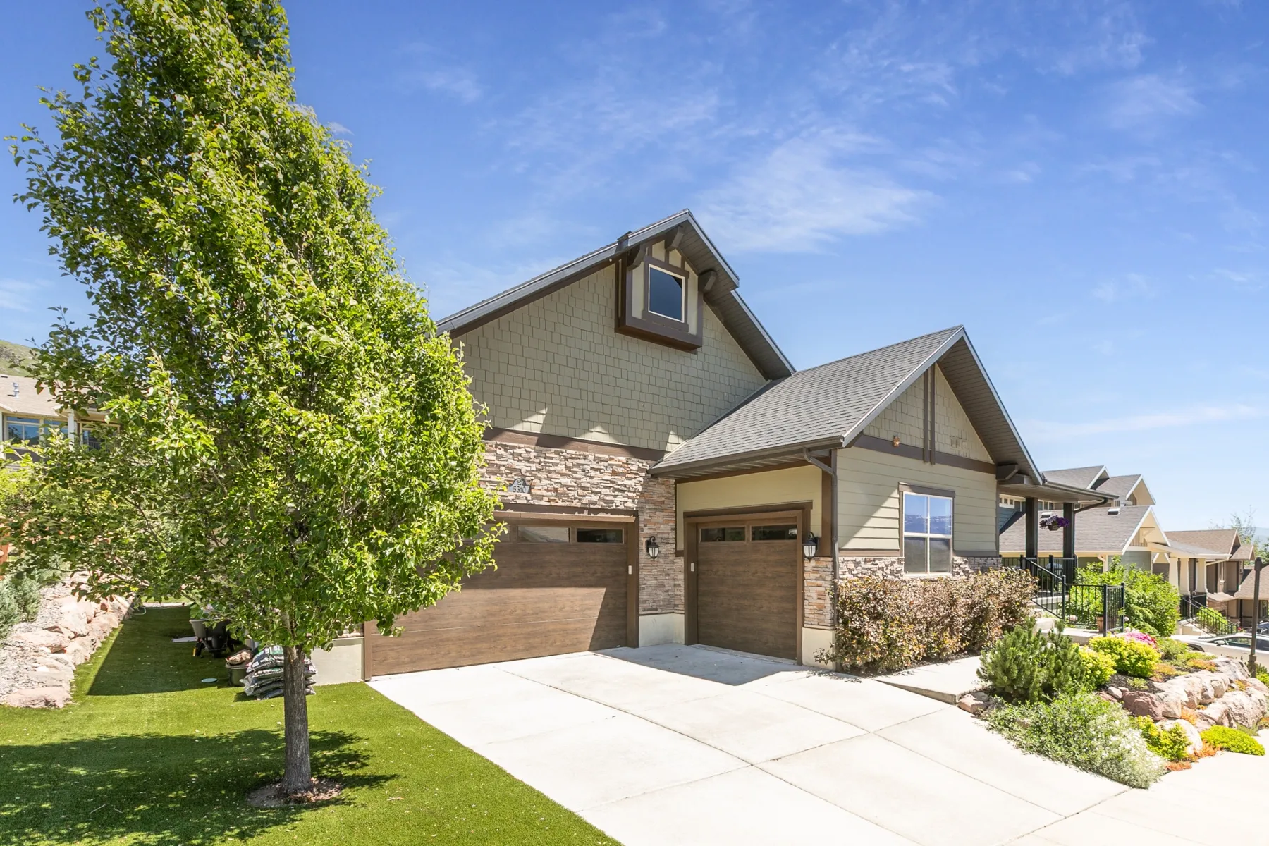Two-story home with a two-car garage and a single-car garage