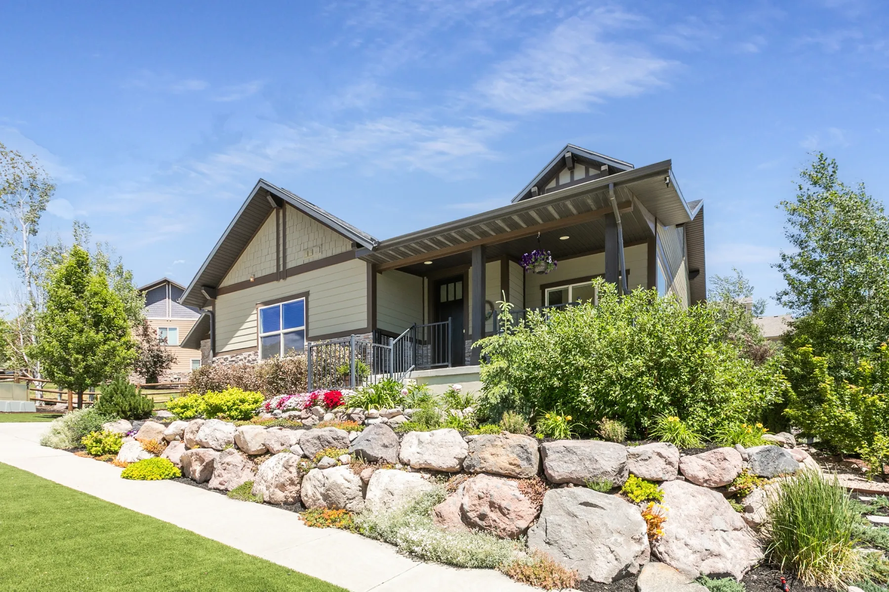 Craftsman-style exterior featuring a covered front porch with dark trim accents
