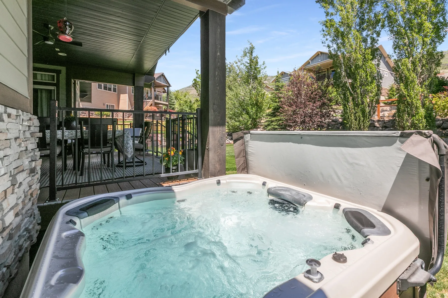 Built-in outdoor hot tub featuring a light-toned shell and dark accents
