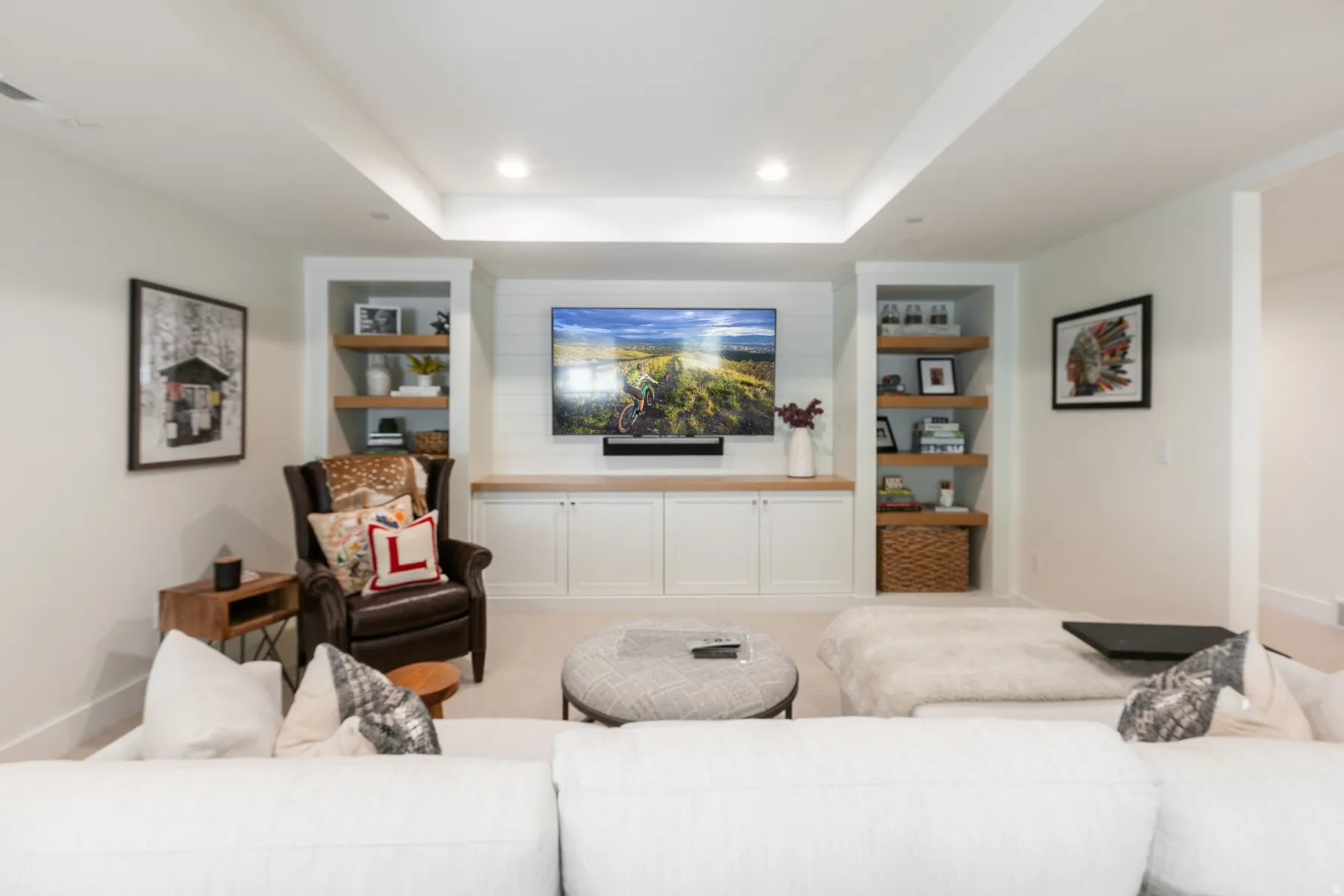 Integrated media wall featuring shiplap detailing, a wood-finish countertop, and built-in cabinetry with shaker-style doors